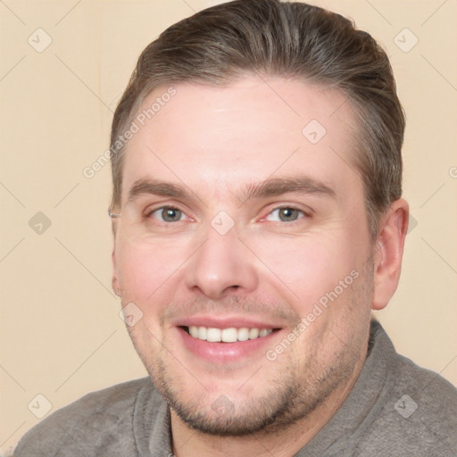 Joyful white young-adult male with short  brown hair and grey eyes