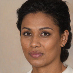 Joyful black adult female with medium  brown hair and brown eyes