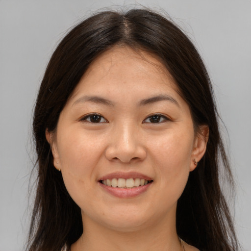 Joyful asian young-adult female with long  brown hair and brown eyes
