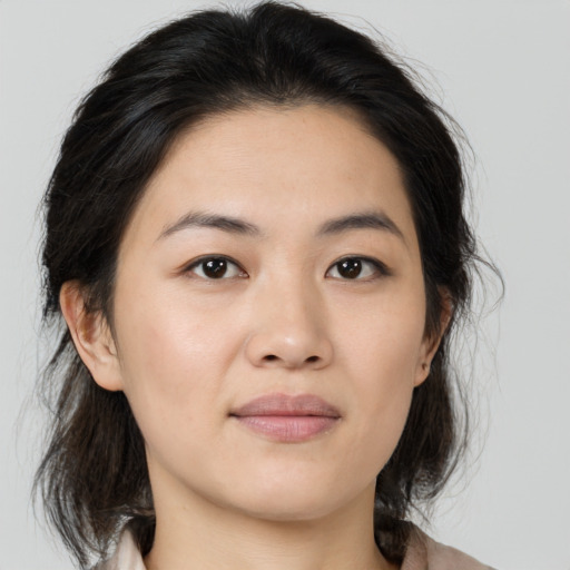 Joyful asian young-adult female with medium  brown hair and brown eyes