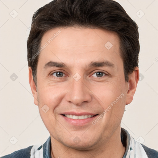 Joyful white adult male with short  brown hair and brown eyes