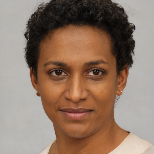Joyful black young-adult female with short  brown hair and brown eyes