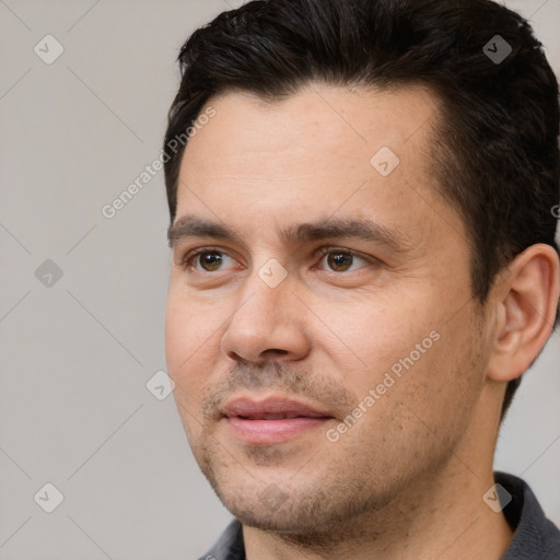 Joyful white adult male with short  black hair and brown eyes