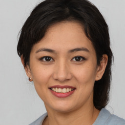 Joyful asian young-adult female with medium  brown hair and brown eyes