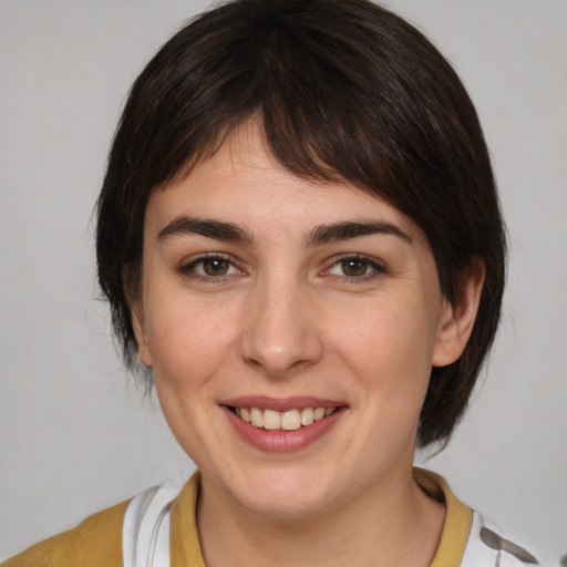 Joyful white young-adult female with medium  brown hair and brown eyes