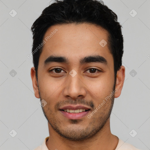 Joyful latino young-adult male with short  black hair and brown eyes