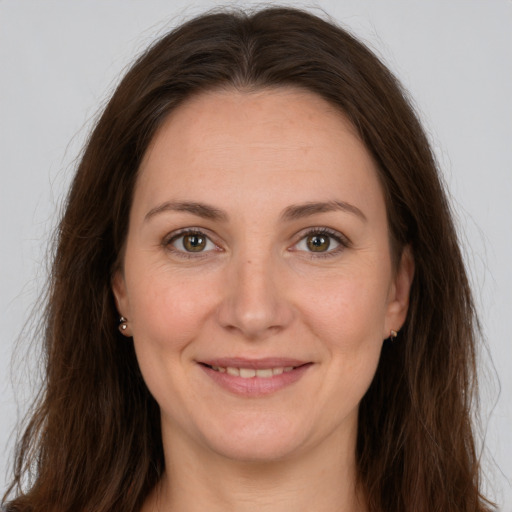 Joyful white adult female with long  brown hair and grey eyes