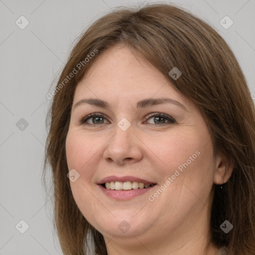 Joyful white adult female with long  brown hair and grey eyes