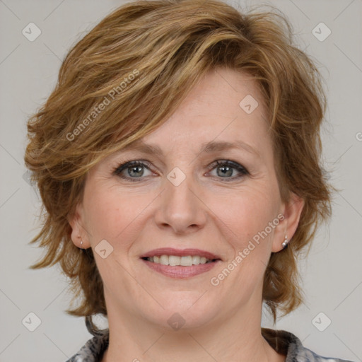 Joyful white adult female with medium  brown hair and grey eyes