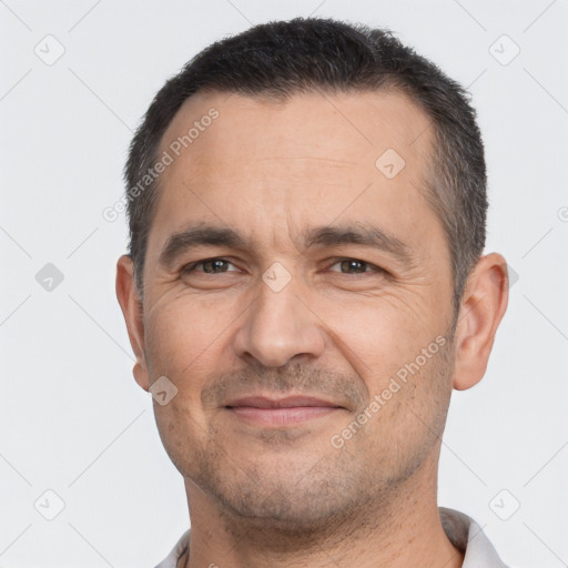 Joyful white adult male with short  brown hair and brown eyes