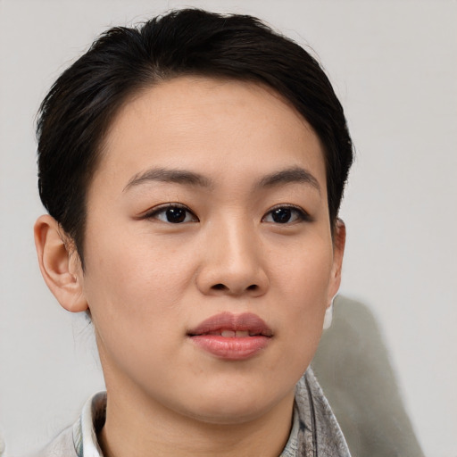 Joyful asian young-adult female with short  brown hair and brown eyes