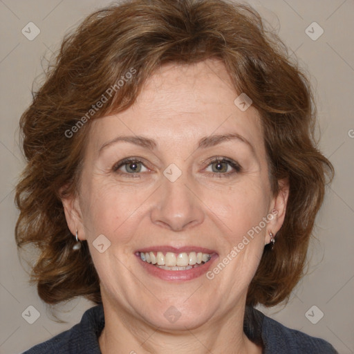 Joyful white adult female with medium  brown hair and blue eyes