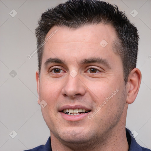 Joyful white adult male with short  brown hair and brown eyes