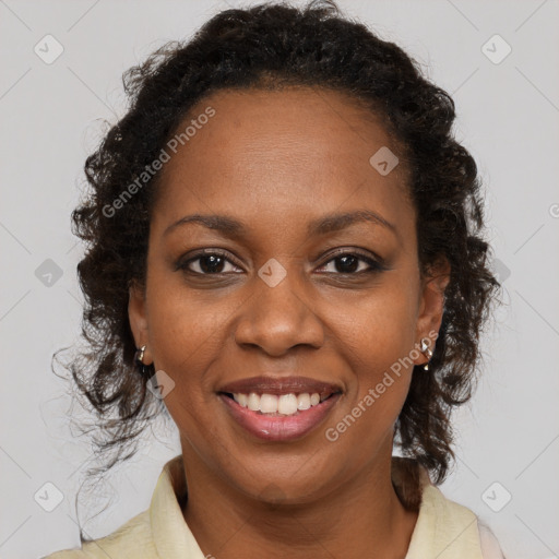 Joyful black young-adult female with long  brown hair and brown eyes