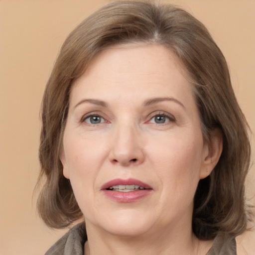 Joyful white adult female with medium  brown hair and grey eyes