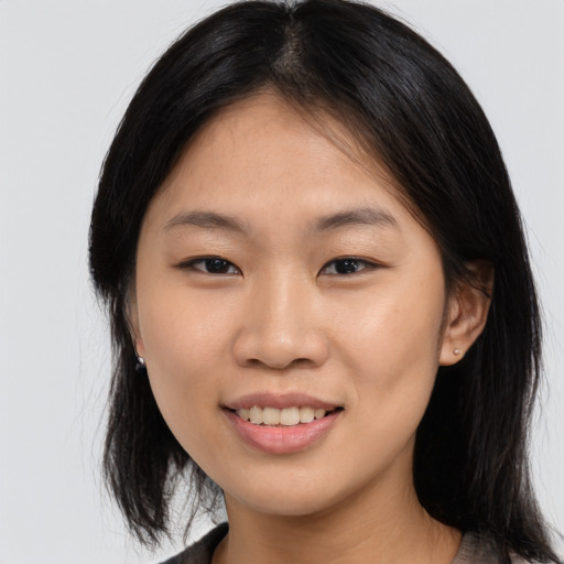 Joyful asian young-adult female with medium  brown hair and brown eyes