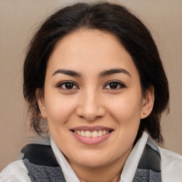 Joyful latino young-adult female with medium  brown hair and brown eyes