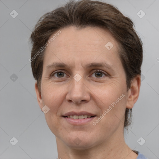 Joyful white adult female with short  brown hair and grey eyes