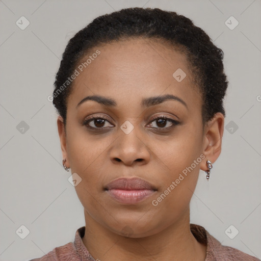 Joyful black young-adult female with short  black hair and brown eyes