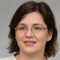 Joyful white adult female with medium  brown hair and brown eyes