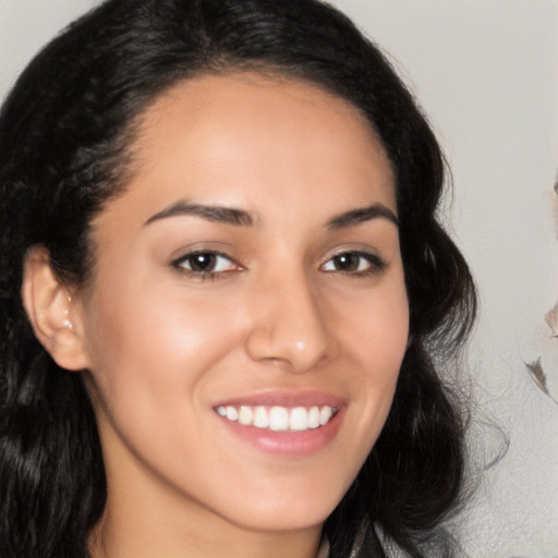 Joyful latino young-adult female with long  brown hair and brown eyes