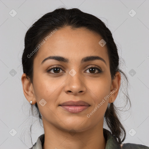 Joyful latino young-adult female with medium  brown hair and brown eyes