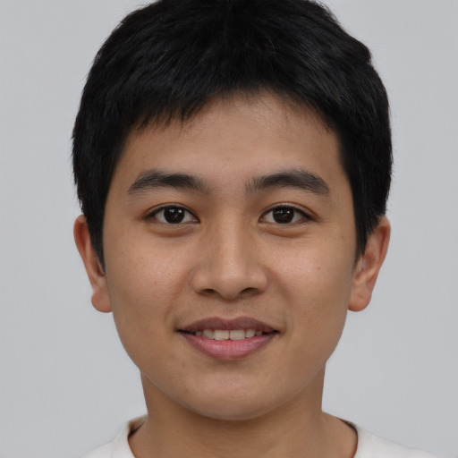 Joyful asian young-adult male with short  brown hair and brown eyes