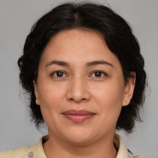 Joyful white adult female with medium  brown hair and brown eyes