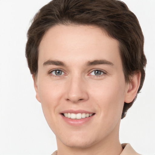 Joyful white young-adult female with short  brown hair and grey eyes