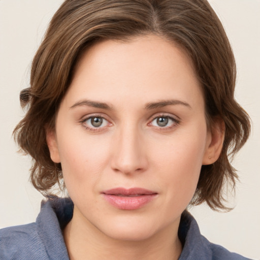 Joyful white young-adult female with medium  brown hair and green eyes