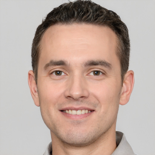 Joyful white young-adult male with short  brown hair and brown eyes