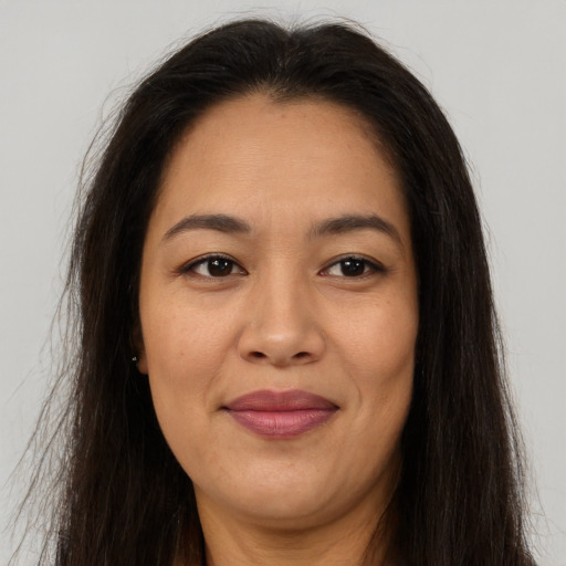 Joyful asian adult female with long  brown hair and brown eyes