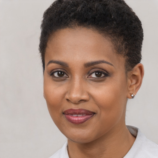 Joyful black young-adult female with short  brown hair and brown eyes