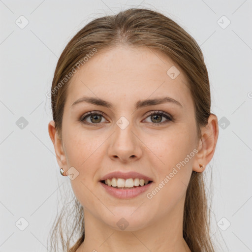 Joyful white young-adult female with long  brown hair and grey eyes