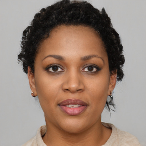 Joyful black young-adult female with short  brown hair and brown eyes