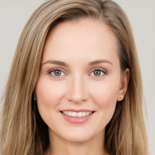 Joyful white young-adult female with long  brown hair and green eyes