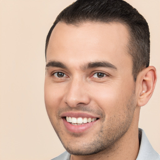 Joyful white young-adult male with short  brown hair and brown eyes