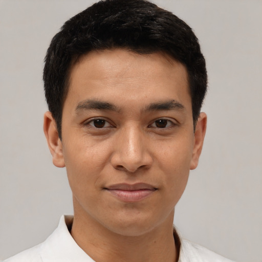 Joyful latino young-adult male with short  brown hair and brown eyes