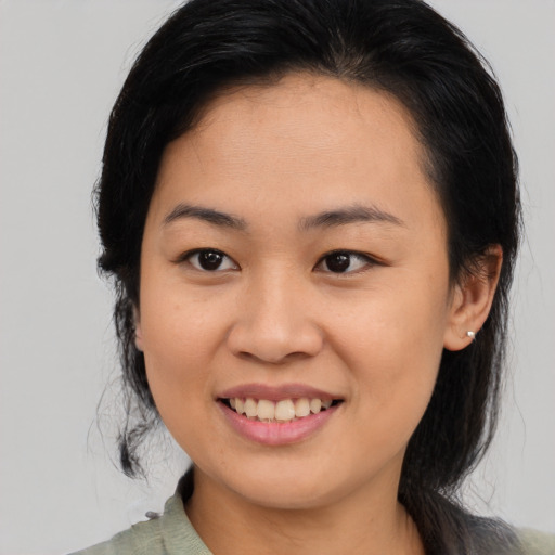 Joyful asian young-adult female with medium  black hair and brown eyes