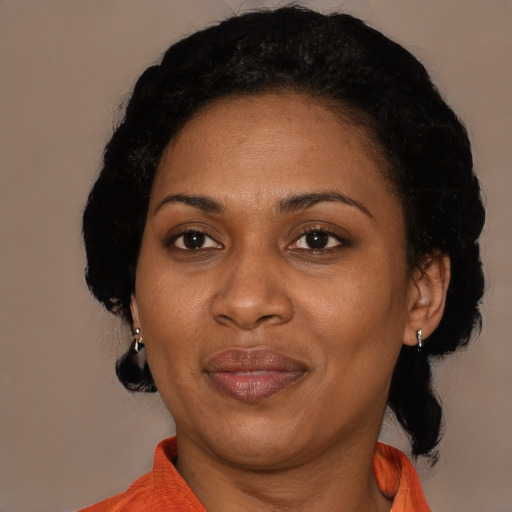 Joyful latino adult female with medium  black hair and brown eyes