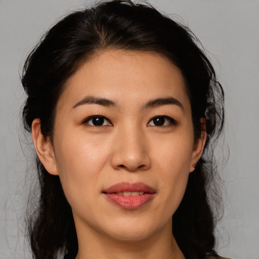 Joyful asian young-adult female with medium  brown hair and brown eyes