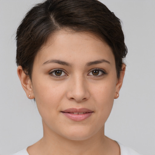 Joyful white young-adult female with short  brown hair and brown eyes