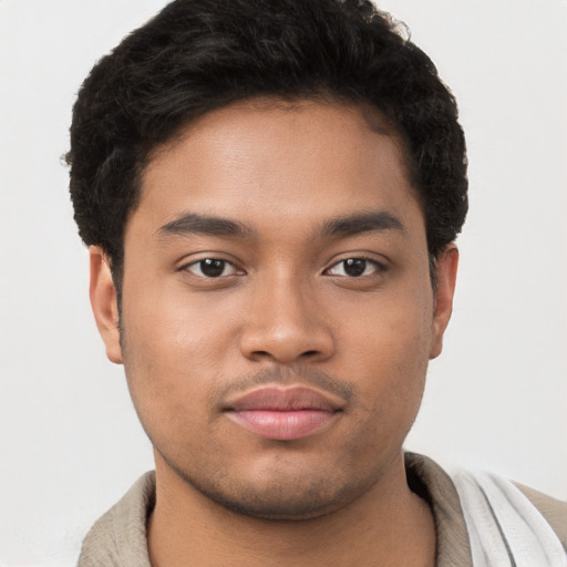 Joyful latino young-adult male with short  brown hair and brown eyes