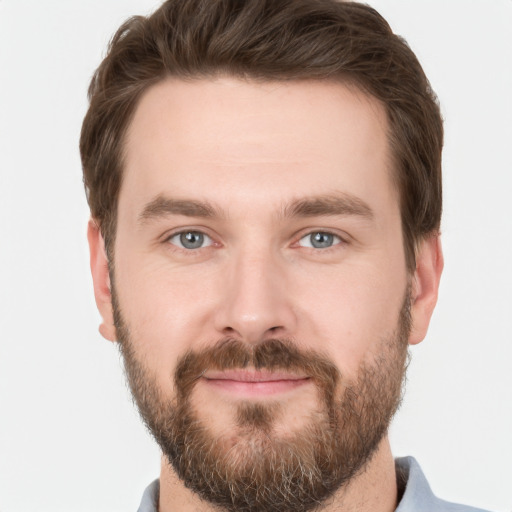 Joyful white young-adult male with short  brown hair and grey eyes