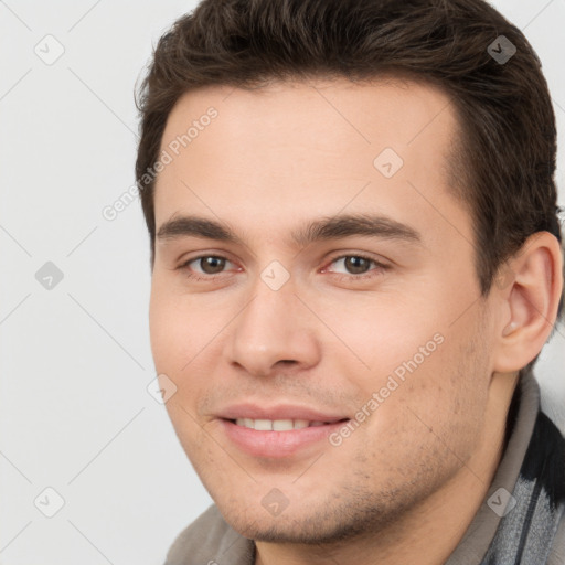 Joyful white young-adult male with short  brown hair and brown eyes