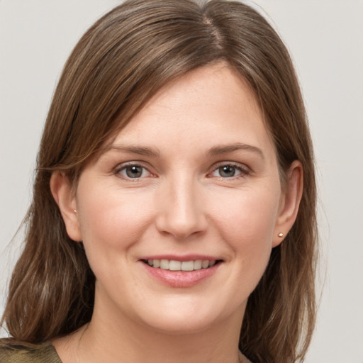 Joyful white young-adult female with medium  brown hair and grey eyes