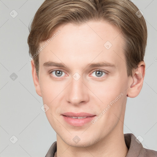 Joyful white young-adult male with short  brown hair and grey eyes