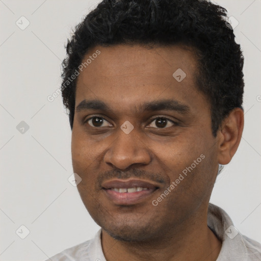 Joyful black young-adult male with short  black hair and brown eyes