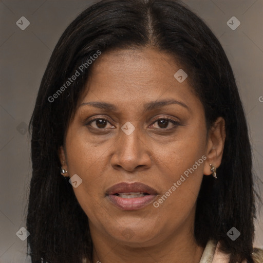 Joyful black adult female with long  brown hair and brown eyes