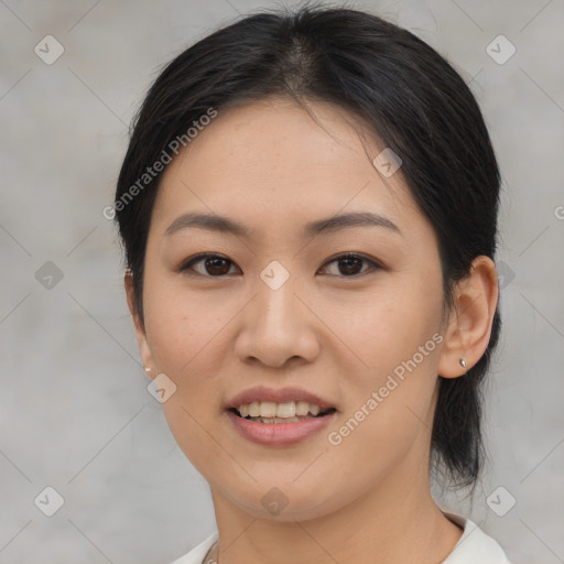 Joyful asian young-adult female with medium  brown hair and brown eyes